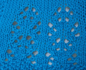 The clever lace motif and seed stitch border at the bottom of the cardiga